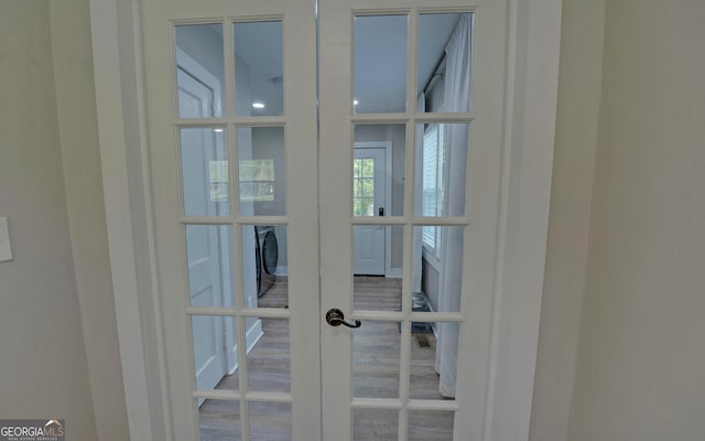 room details featuring french doors and washer / clothes dryer
