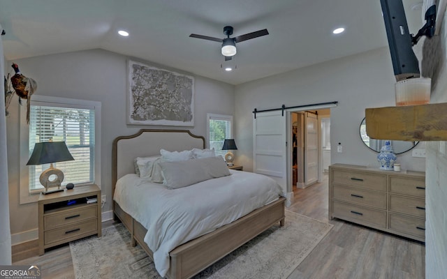 bedroom with baseboards, ceiling fan, recessed lighting, a barn door, and light wood finished floors