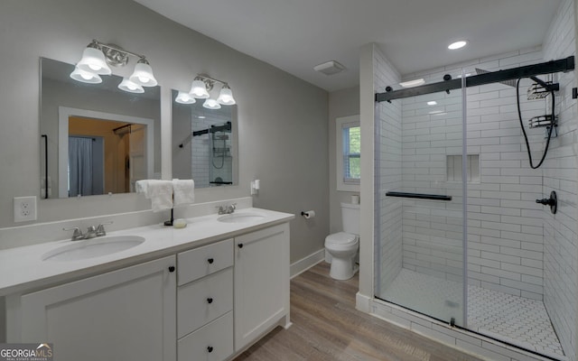 full bath featuring wood finished floors, a sink, and a stall shower