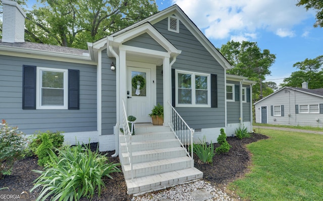 bungalow-style house with a front yard