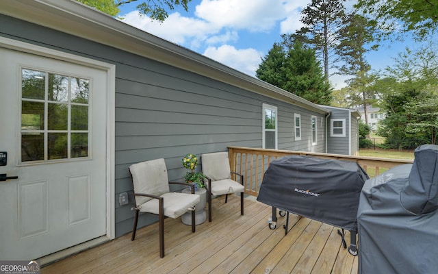 wooden terrace featuring a grill
