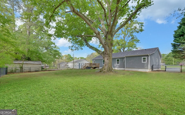 view of yard with a fenced backyard and a wooden deck