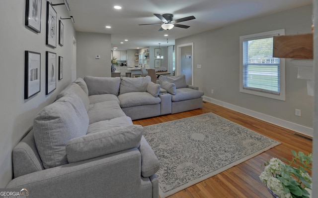 living room with visible vents, wood finished floors, baseboards, ceiling fan, and recessed lighting