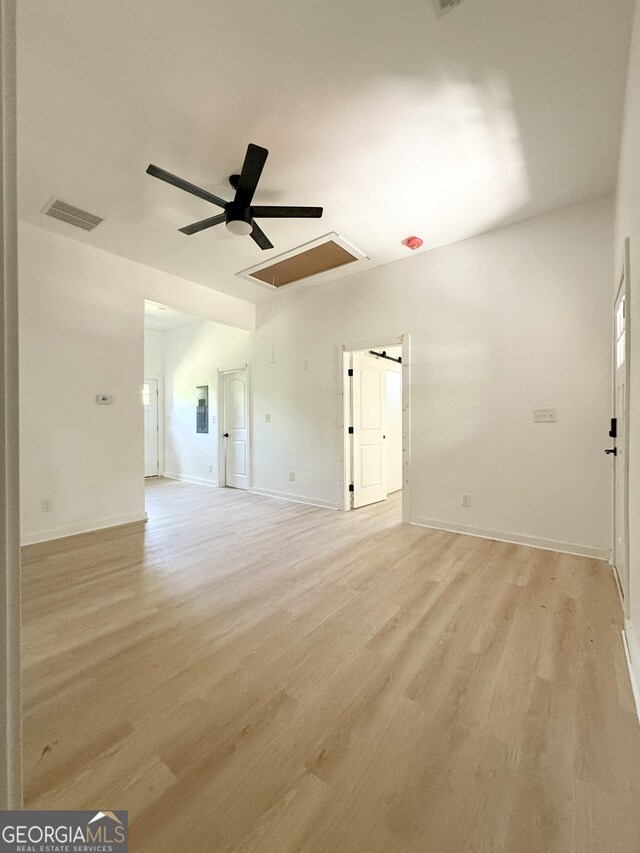 808 Center St, Macon, GA 31217 - unfurnished living room with attic access, a ceiling fan, light wood-type flooring, and baseboards
