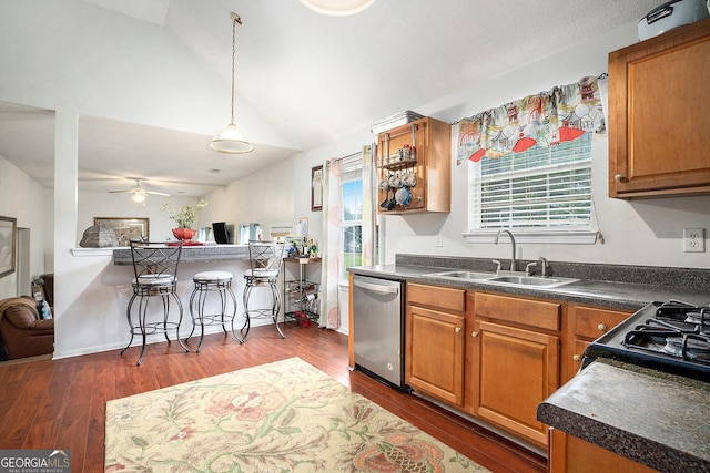 436 Berkshire Pl, Fairburn, GA 30213 - kitchen with stainless steel dishwasher, a sink, vaulted ceiling, dark countertops, and brown cabinetry
