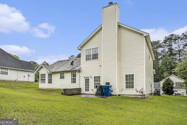 436 Berkshire Pl, Fairburn, GA 30213 - back of property featuring a chimney, a patio area, a yard, and central AC