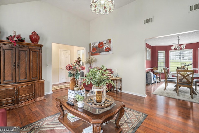 436 Berkshire Pl, Fairburn, GA 30213 - living room with a chandelier, high vaulted ceiling, dark wood finished floors, and baseboards