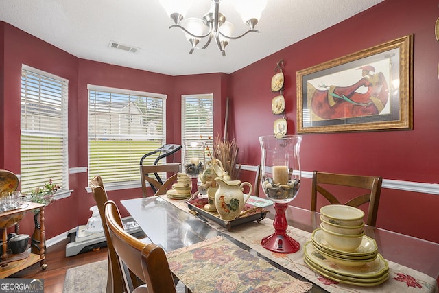 436 Berkshire Pl, Fairburn, GA 30213 - dining area featuring a chandelier, baseboards, and wood finished floors