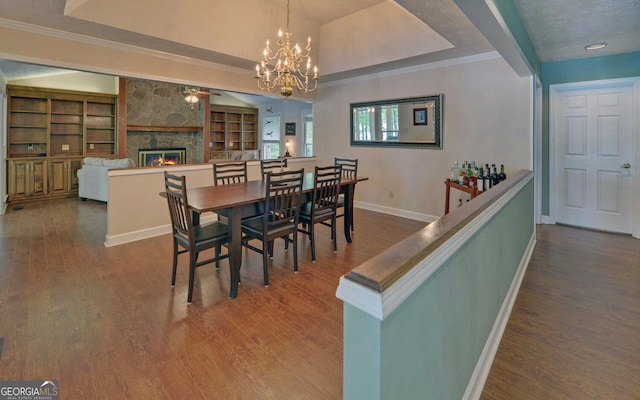 119 Ridgemore Cir, Toccoa, GA 30577 - dining space with a fireplace, wood finished floors, ornamental molding, a chandelier, and built in shelves