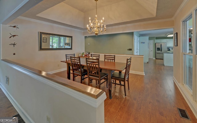 119 Ridgemore Cir, Toccoa, GA 30577 - dining area with wood finished floors, a chandelier, baseboards, a raised ceiling, and crown molding