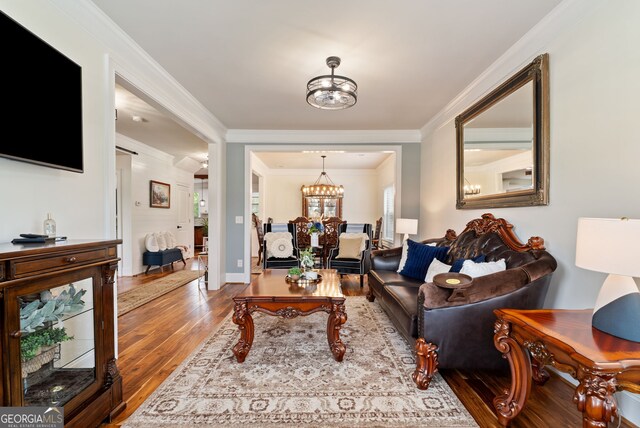 721 Paint Horse Dr, Canton, GA 30115 - living area with wood finished floors, a chandelier, ornamental molding, and baseboards
