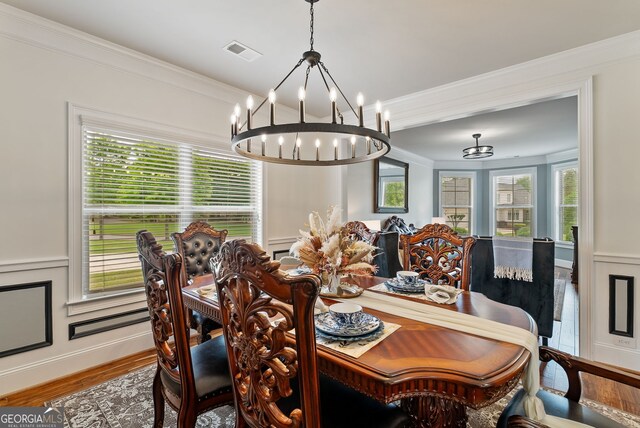 721 Paint Horse Dr, Canton, GA 30115 - dining space featuring a chandelier, wood finished floors, and ornamental molding