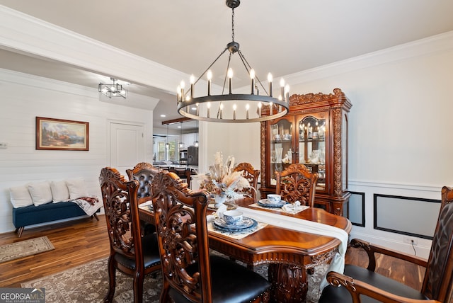 721 Paint Horse Dr, Canton, GA 30115 - dining area featuring a chandelier, ornamental molding, wood finished floors, a decorative wall, and wainscoting