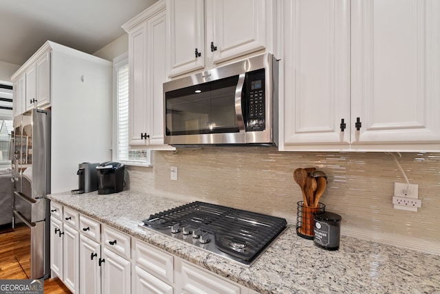721 Paint Horse Dr, Canton, GA 30115 - kitchen featuring stainless steel appliances, white cabinetry, backsplash, and light stone countertops