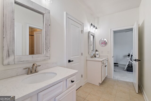 721 Paint Horse Dr, Canton, GA 30115 - bathroom with two vanities, tile patterned flooring, and baseboards
