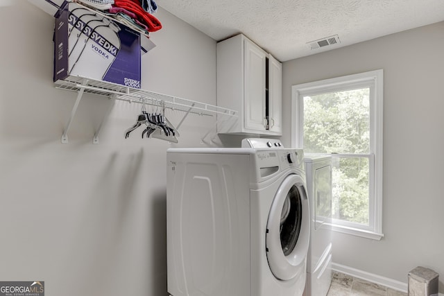 5922 Terrace Lake Pt, Flowery Branch, GA 30542 - laundry room with washer and clothes dryer, healthy amount of natural light, and cabinet space