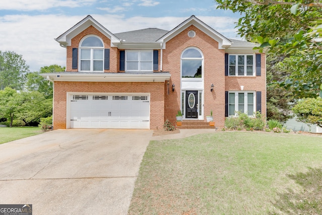 5922 Terrace Lake Pt, Flowery Branch, GA 30542 - view of front of home featuring concrete driveway, a front lawn, a garage, and brick siding