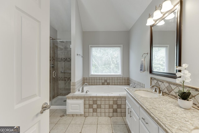 5922 Terrace Lake Pt, Flowery Branch, GA 30542 - bathroom featuring tile patterned flooring, a bath, vanity, healthy amount of natural light, and lofted ceiling