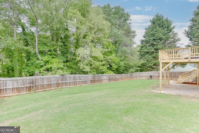 5922 Terrace Lake Pt, Flowery Branch, GA 30542 - fenced backyard with a wooden deck and stairway