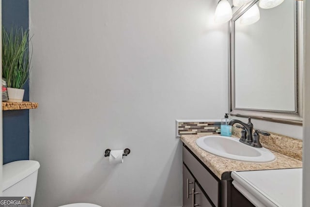 half bath with vanity and toilet
