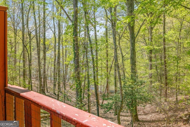 balcony featuring a forest view