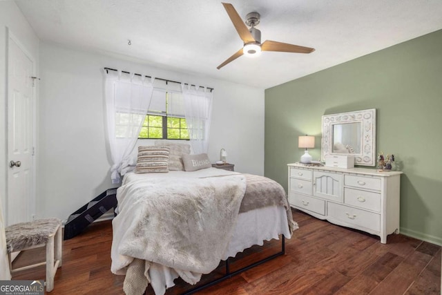 bedroom with baseboards, dark wood finished floors, and ceiling fan