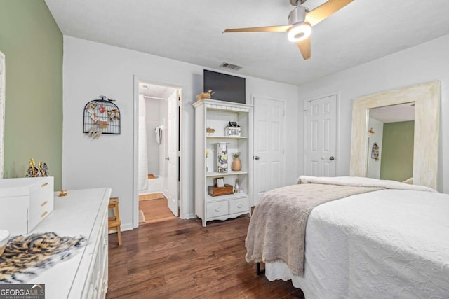 bedroom featuring visible vents, a closet, dark wood-type flooring, a ceiling fan, and ensuite bath