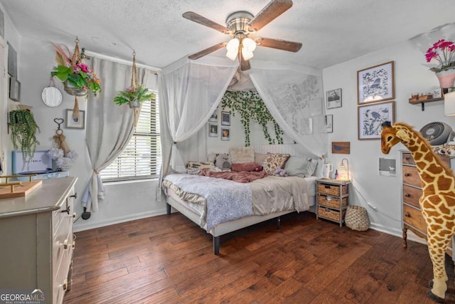 bedroom with baseboards, a ceiling fan, dark wood finished floors, and a textured ceiling
