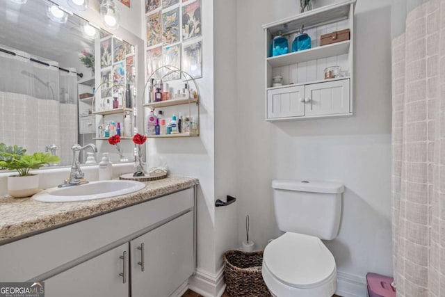 bathroom with vanity, a shower with shower curtain, and toilet