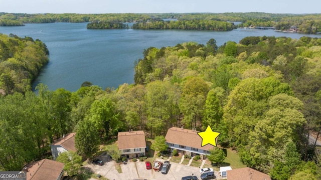 bird's eye view with a water view and a forest view