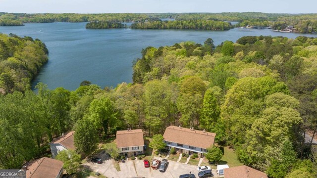 birds eye view of property featuring a water view and a forest view