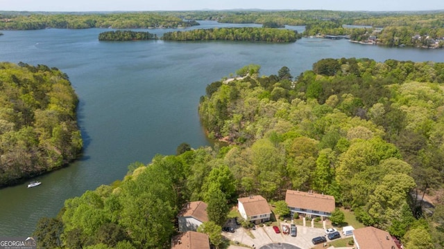 aerial view featuring a water view and a wooded view