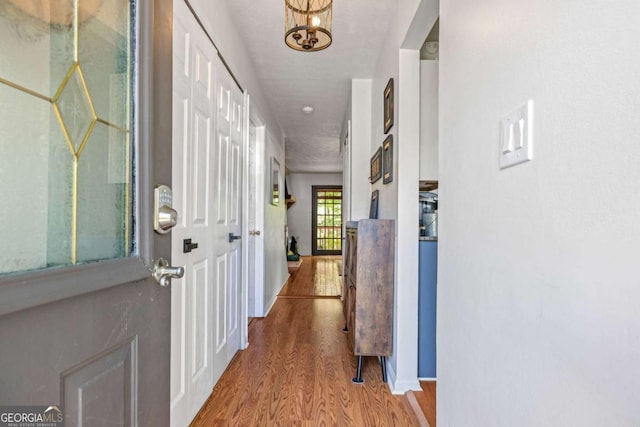 hallway with baseboards and wood finished floors