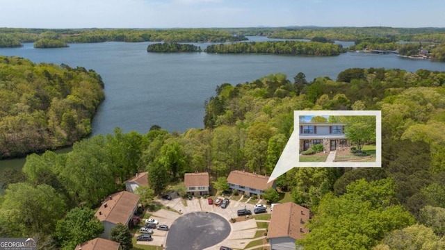 birds eye view of property featuring a water view and a forest view