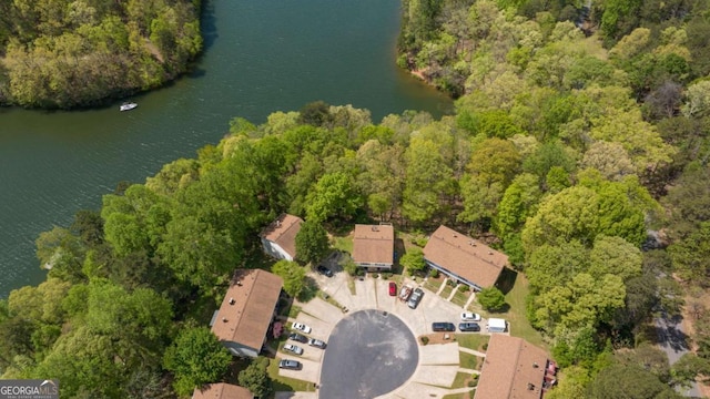drone / aerial view featuring a water view and a view of trees