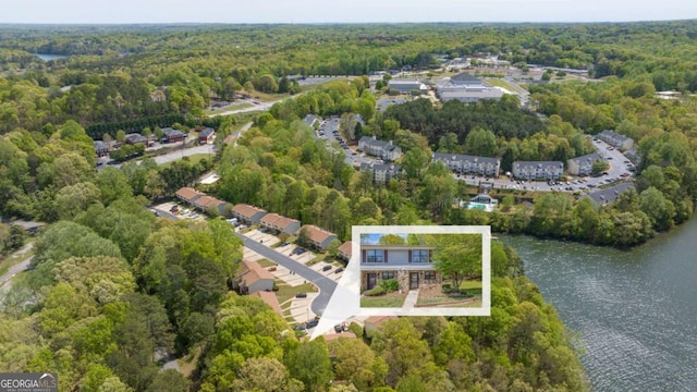 bird's eye view featuring a water view and a view of trees