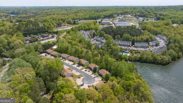 birds eye view of property with a water view and a view of trees