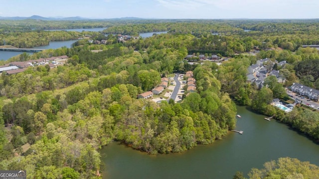 bird's eye view with a water view and a wooded view