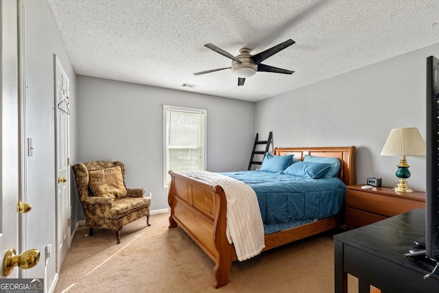 bedroom featuring a ceiling fan, carpet flooring, a textured ceiling, and visible vents