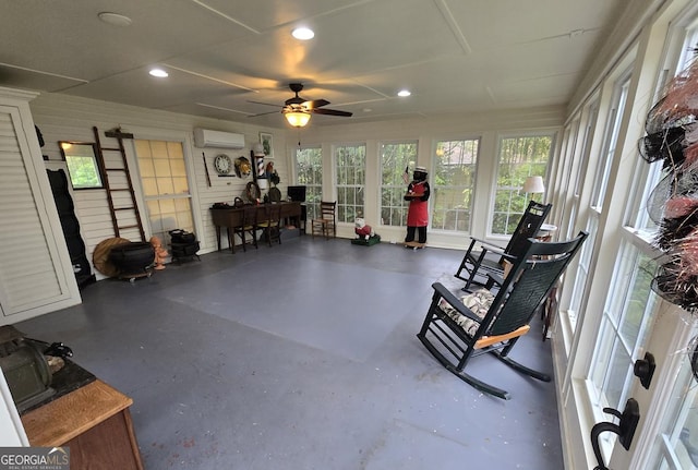 sunroom with recessed lighting, concrete floors, and a wall mounted AC