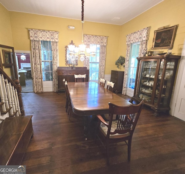 dining space with an inviting chandelier, wood-type flooring, and stairs