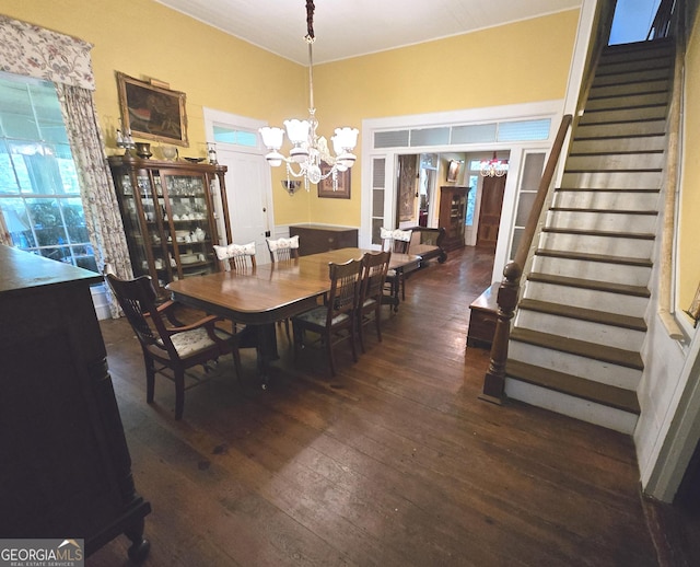 dining area with an inviting chandelier, stairs, and hardwood / wood-style floors