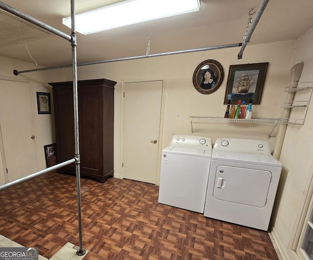 clothes washing area with washing machine and clothes dryer and laundry area