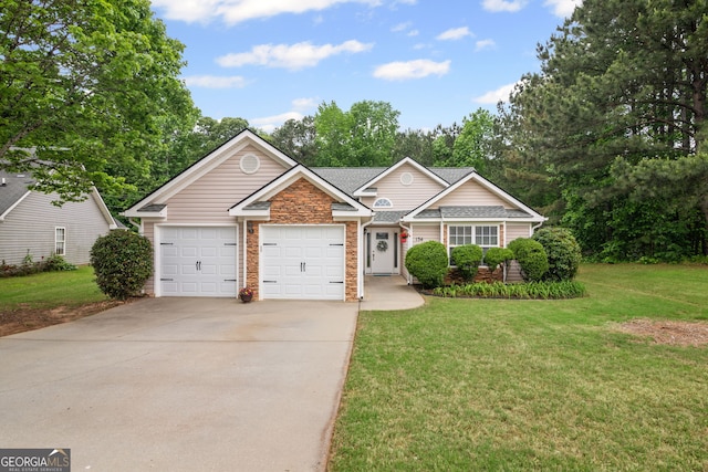 view of front of house featuring a shingled roof, brick siding, a garage, a front yard, and driveway