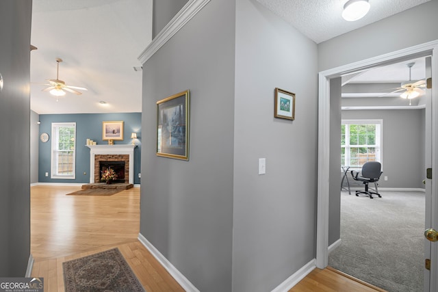 corridor featuring baseboards and light wood-style flooring