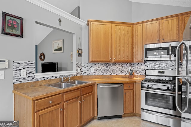 kitchen featuring stainless steel appliances, vaulted ceiling, a sink, and tasteful backsplash