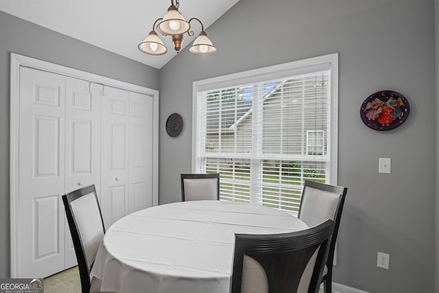 dining area with light tile patterned flooring and vaulted ceiling