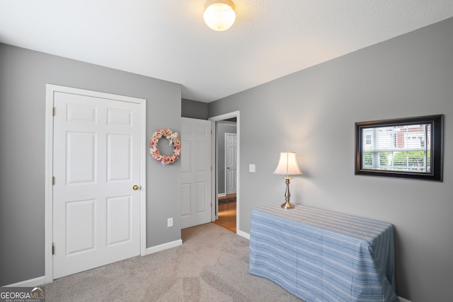 carpeted bedroom featuring baseboards