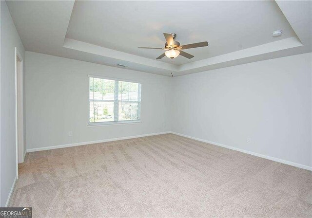 2539 Hedgeway Cir, Kennesaw, GA 30144 - carpeted empty room with baseboards, a raised ceiling, and ceiling fan