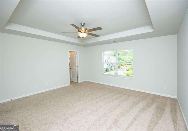 2539 Hedgeway Cir, Kennesaw, GA 30144 - empty room featuring light colored carpet, a ceiling fan, a raised ceiling, and baseboards